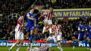 Ryan Shawcross is floored by Everton midfielder Marouane Fellaini 