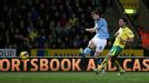Edin Dzeko shoots on goal as Manchester City net their fourth at Norwich
