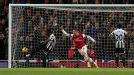 Lukas Podolski celebrates after putting Arsenal 3-2 ahead with a close-range finish