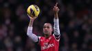 Theo Walcott celebrates with the match ball after his hat-trick helped Arsenal to a 7-3 victory