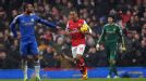 Theo Walcott returns to the centre circle after scoring against Chelsea