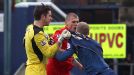 Tempers flare as Liverpool's Martin Skrtel confronts Oldham's Robbie Simpson after a late challenge on Brad Jones