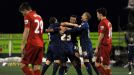 Reece Wabara is mobbed by his team-mates after making it 3-1 to Oldham