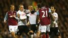 Steve Sidwell is held back by his Fulham team-mates as he squares up to West Ham's Mohamed Diame
