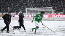 Brandao clears snow of the St Etienne pitch to make sure their game against Montpellier is completed