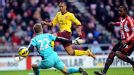 Theo Walcott is denied by the post as he looks to increase Arsenal's advantage