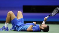Djokovic falls to the court after losing tough rally to Medvedev