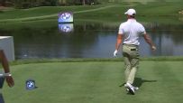 McIlroy bounces his 3-wood into the water after errant tee shot