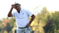 Si Woo Kim takes his hat off before his winning putt drops in