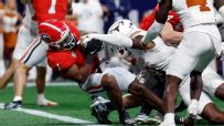 Georgia wins SEC title on injured Beck handoff to Etienne in OT