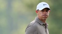 Rory chips through green into the water
