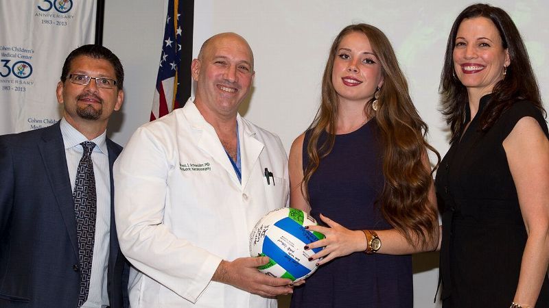 Courtesy of NICO Corporation Blakely Murphy with Jim Pearson, left, CEO of NICO, which created the NICO BrainPath procedure; Dr. Steven Schneider, who operated on Murphy both times she developed a brain tumor; and her mother, Dawn.