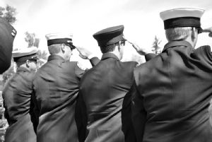 Firefighters salute at Will Caviness' memorial service