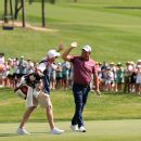 Padraig Harrington celebrates a birdie, remaining tied for the lead.