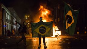 masked protestor Brazil flag Rio de Janeiro
