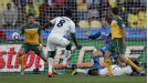 Harry Kewell uses his arm to prevent Jonathan Mensah's shot from hitting the back of the net