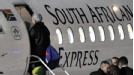 Raymond Domenech boards a plane after defeat to South Africa