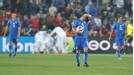 Italy's Antonio Di Natale (centre) stands dejected after conceding their second goal as Slovakia players celebrate