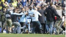 City fans invade the pitch at Eastlands at the final whistle