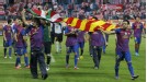 Barcelona players hold Basque and Catalan flags aloft at the end of the Copa del Rey final