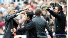 Arsene Wenger and the Arsenal bench celebrate at full-time after booking a place in the Champions League
