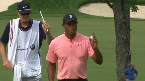 Tiger Woods chips shot to set him up for a birdie on the 11th hole dropping him to-9