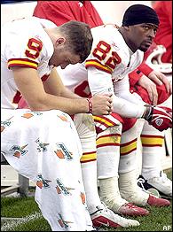 Jason Baker, left, and Dante Hall, right, sit on the bench at the end 