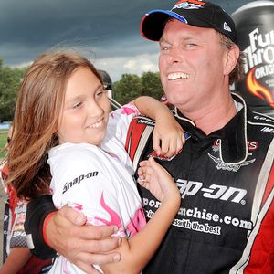 Doug Herbert hugs daughter Jessie after his Top Fuel win Sunday.