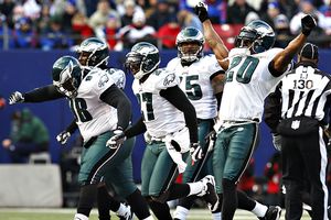 Eagles' Brian Dawkins (20), Quintin Mikell (27) and Mike Patterson (98)