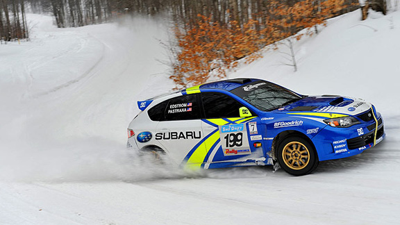Mirra, at the wheel of his 2011 Subaru Impreza WRX STI rally car, 