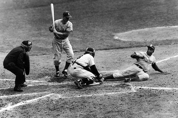 Yankee catcher, Yogi Berra, center, hands out the balls to the top