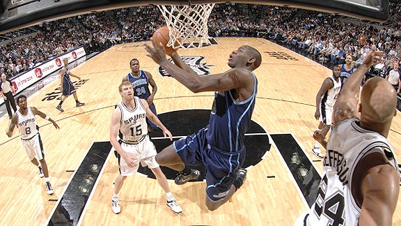 Utah Jazz forward Carlos Boozer, right, grabs the ball as San Antonio Spurs  forward Tim Duncan, left, drives to the basket during the first half of  their NBA basketball game Thursday, Nov.