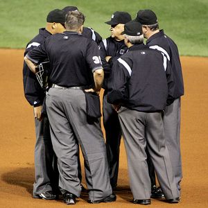 Umpires huddle to make a ruling