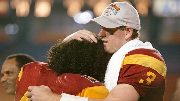 Carson Palmer of USC hugs teammate Troy Polamalu