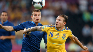 France's Mathieu Debuchy, left, and Ukraine's Andriy Voronin vie for the ball on a wet night in Donetsk, Ukraine.