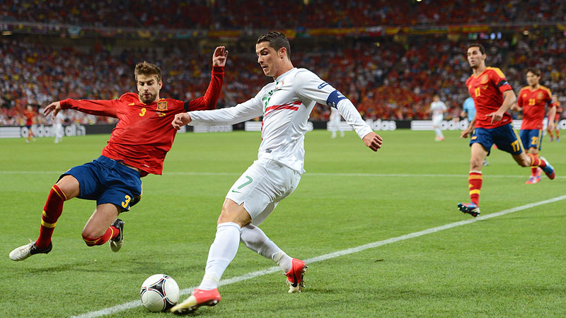 Gerard Pique of Spain defends from Cristiano Ronaldo of Portugal during the Euro 2012 semifinals in Donetsk.