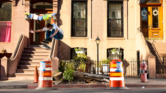 Jake Johnson - frontside flip, Brooklyn, NY. Jake frontside flips over construction materials surrounding a tree root bump near the Cosby house.