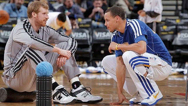 Stephen Curry #30 of the Golden State Warriors talks with Matt Bonner #15 of the San Antonio Spurs on April 15, 2013 at Oracle Arena in Oakland, California.