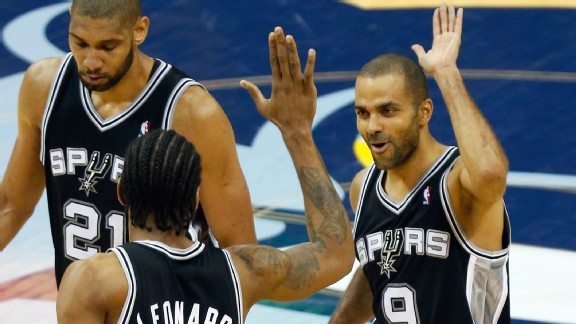 an Antonio Spurs' Kawhi Leonard (2) congratulates teammate Tony Parker (9), of France, after making a basket against the Memphis Grizzlies in overtime during Game 3 of the Western Conference finals NBA basketball playoff series, Saturday, May 25, 2013, in