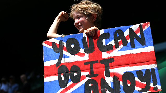 A young tennis fan holds a Union Jack banner with a message of support for Andy Murray of Great Britain