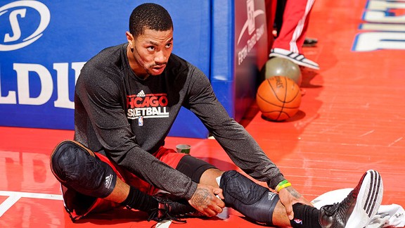 Derrick Rose #1 of the Chicago Bulls stretches before his team's game against the Detroit Pistons on April 7, 2013 at The Palace of Auburn Hills in Auburn Hills, Michigan.