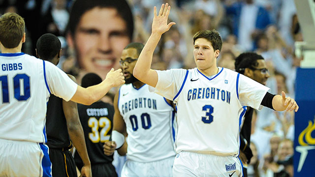 Doug McDermott #3 of the Creighton Bluejays high fives teammate Grant Gibbs #10 during their game at the CenturyLink Center on March 2, 2013 in Omaha, Nebraska.