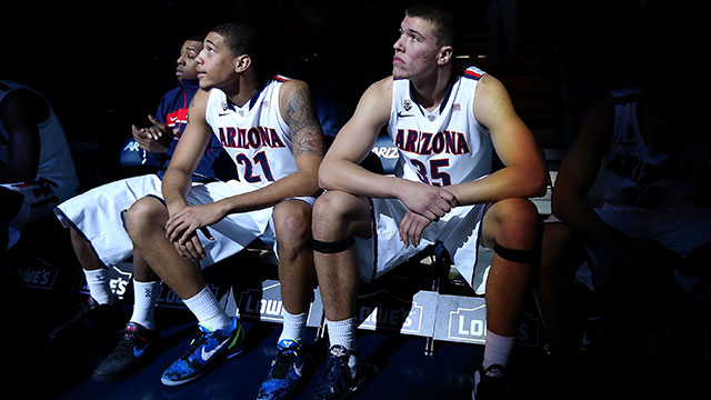 Brandon Ashley #21 and Kaleb Tarczewski #35 of the Arizona Wildcats sit on the bench during introductions to the college basketball game against the Northern Arizona Lumberjacks at McKale Center on November 28, 2012 in Tucson, Arizona.