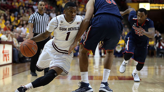 Jahii Carson #1 of the Arizona State Sun Devils drives the ball past Grant Jerrett #33 of the Arizona Wildcats during the college basketball game at Wells Fargo Arena on January 19, 2013 in Tempe, Arizona.