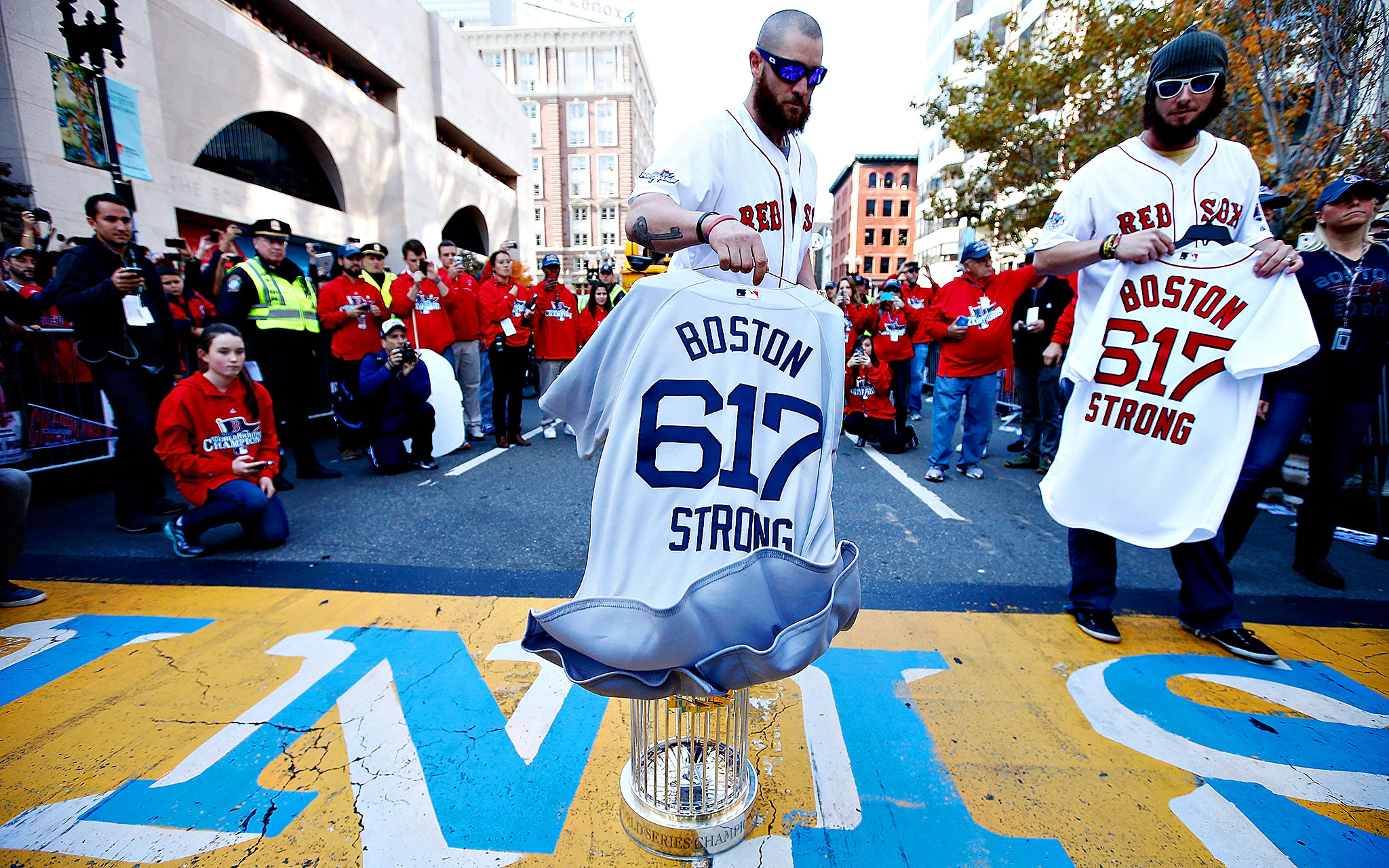 Red Sox OF Jonny Gomes places Boston Strong jersey at Marathon Finish line