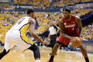 LeBron James (6) drives the ball against Indiana Pacers forward Paul George