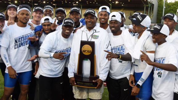Florida coach Mike Holloway is surrounded by his athletes after winning the national title.