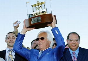 Trainer Bob Baffert, center, owner Ahmed Zayat, right, and his son Justin Zayat, left, celebrate after American Pharoah's runaway victory in Sunday's Haskell.
