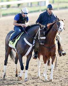 Oxbow, left, finishes a workout at Churchill Downs while his trainer D. Wayne Lukas look on.