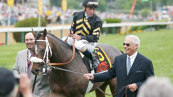 Orb heads to the Preakness Stakes winner's circle with jockey Gary Stevens and trainer D. Wayne Lukas.